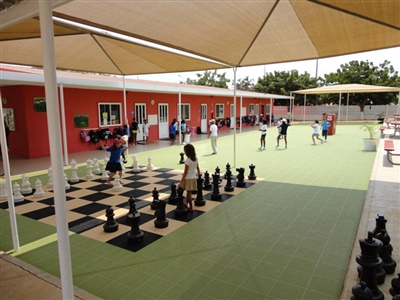 Multipurpose outdoor sport court with green flooring and giant chess board in Madison.